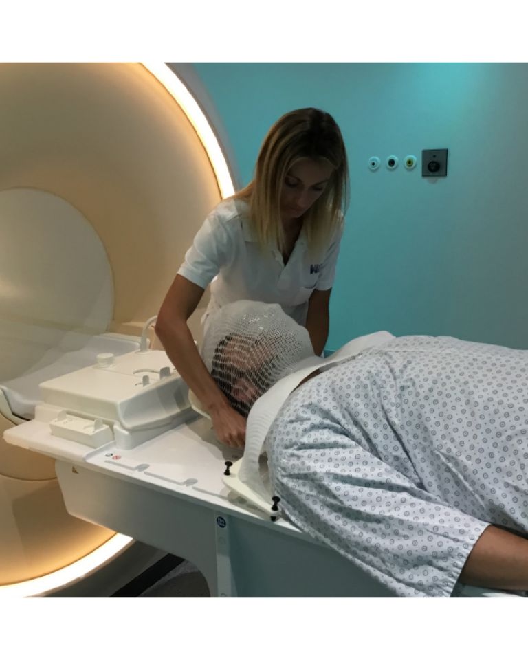 Radiotherapy patient with mask on MRI couch 