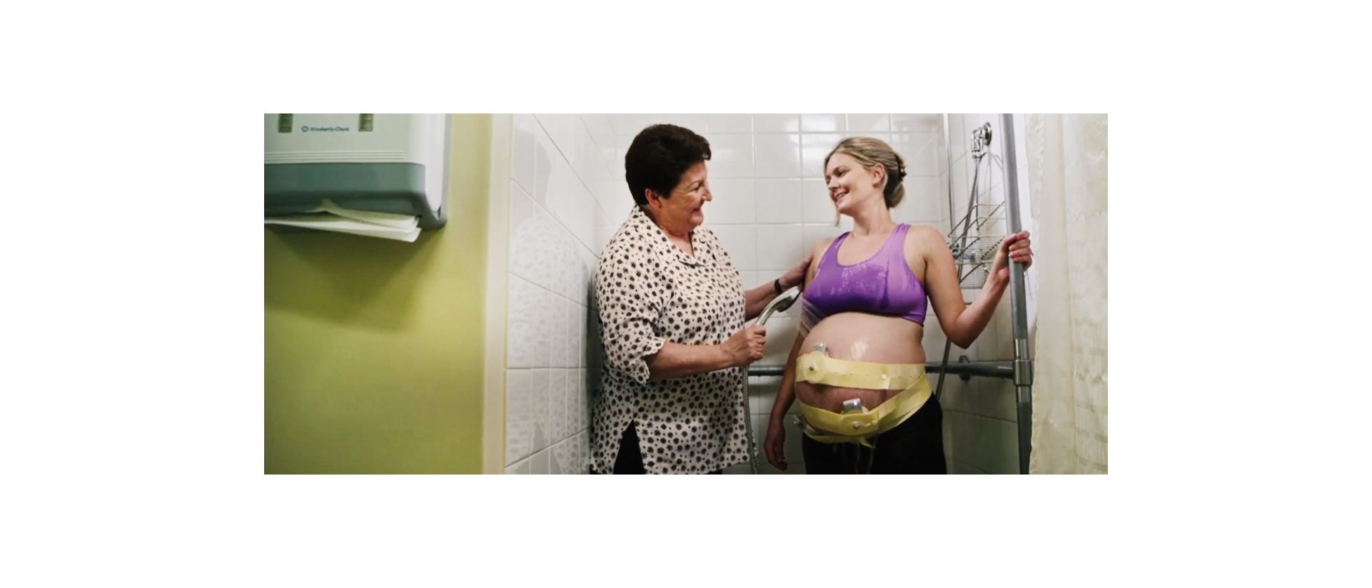 Transducers being placed on a pregnant patient