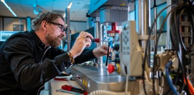 Mark Olof Dirksen adjusting laboratory testing equipment in research lab