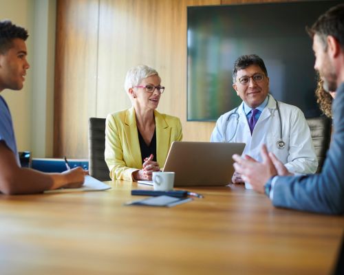 Stakholders collaborate during a hospital meeting.