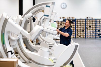 Refurbishment process engineer working on Azurion in factory  