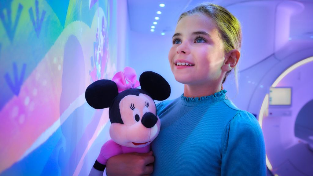 Girl with Minnie doll playing with Disney Ariel theme