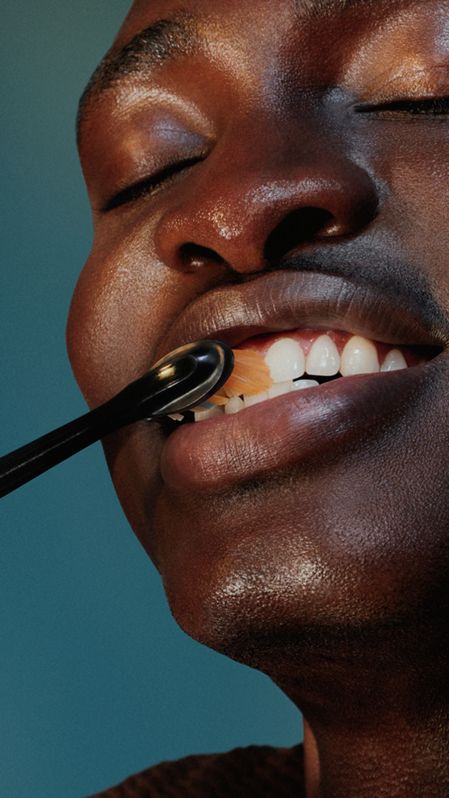 Woman using a Philips Sonicare power toothbrush