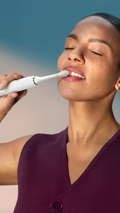 A woman brushing with a Philips Sonicare DiamondClean Smart.