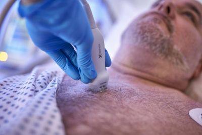 Clinician performing cardiac ultrasound using Philips X5-1c transthoracic transducer