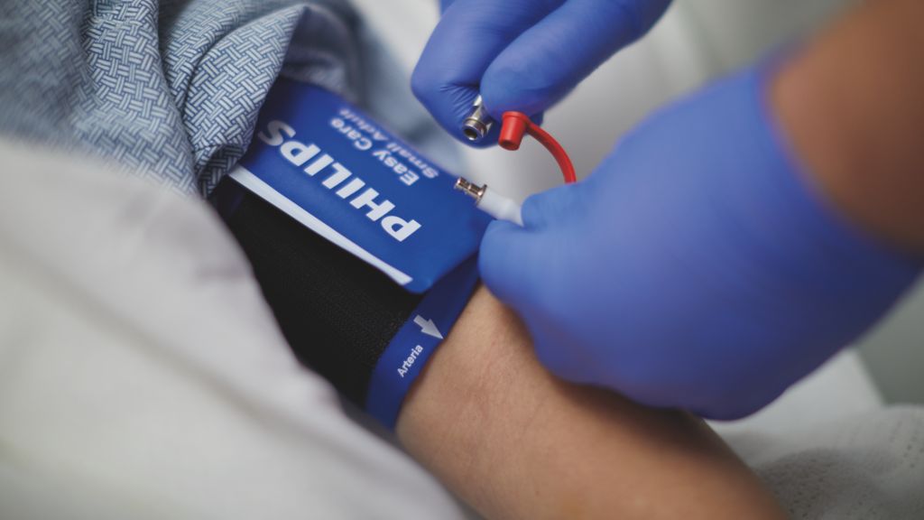 clinician placing NBP cuff on patient 
