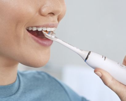 Patient brushing behind front teeth.