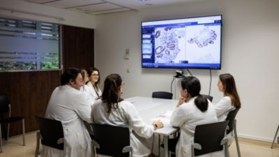 Pathology specialists reviewing digital slides in clinical meeting