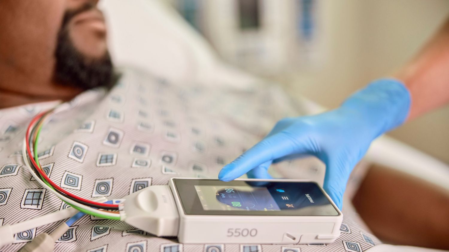 patient wearing 5500 and clinician touching the screen