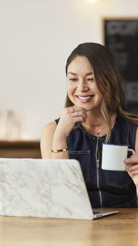 Woman using a laptop and smiling