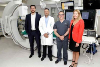 Clinical team standing in interventional suite with Philips Azurion system