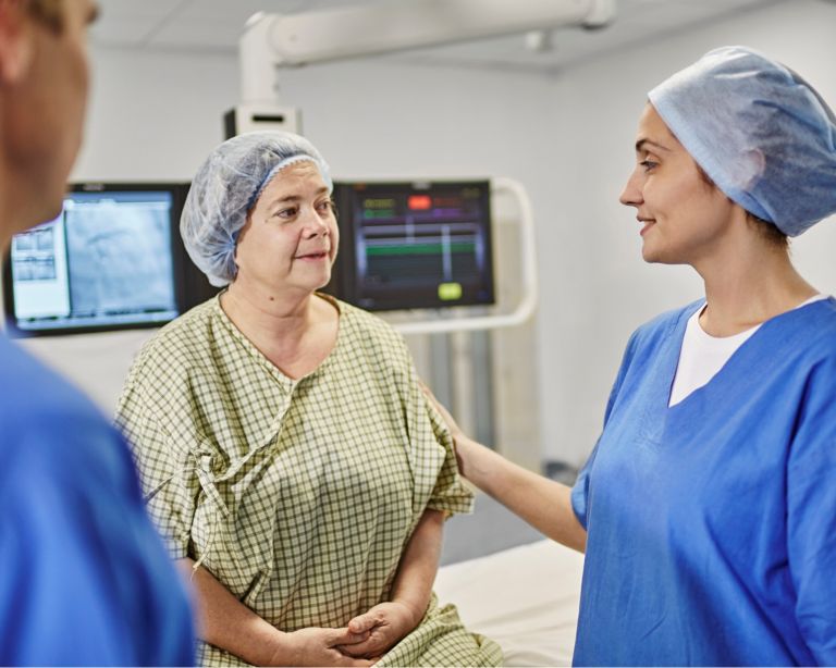 Une infirmière réconforte un patient avant une intervention