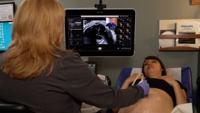 Specialist providing remote guidance during tele ultrasound exam for high risk pregnancy

