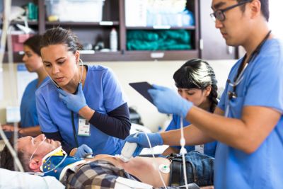 Medical team in blue scrubs providing emergency care to a patient