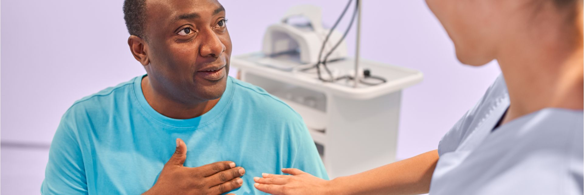 male patient touching the area of his heart