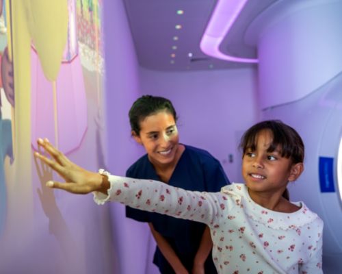 Pediatric Coaching - Girl playing with Ollie in Space theme prior to MRI exam and nurse watching - Ambient Experience