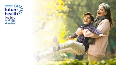 Elderly woman swinging child outdoors