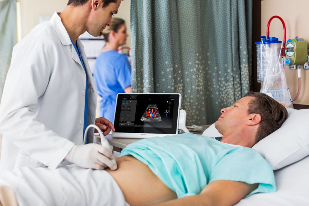 InnoSight patient bedside abdominal scan with doctor and patient, using C6-2 transducer