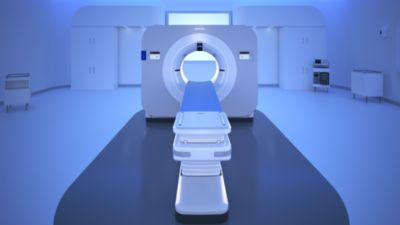Philips spectral CT 7500 system in a blue-lit examination room
