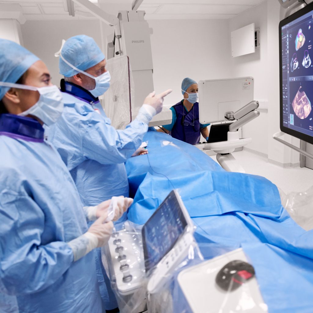 Care providers with EchoNavigator in a cardiac procedure