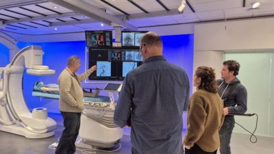 Medical professional demonstrating Philips Azurion system to visitors in experience center
