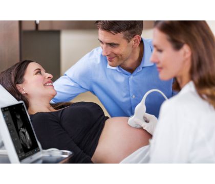 InnoSight in scanning room with spouse and doctor scanning OB patient with C6-2
