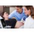 InnoSight in scanning room with spouse and doctor scanning OB patient with C6-2 thumbnail