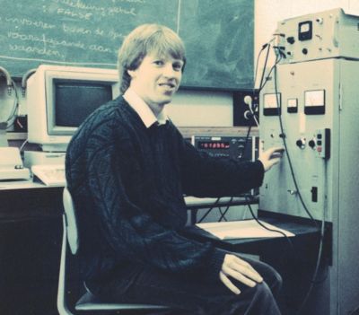 Young Mark Johnson working with electronic equipment in research laboratory