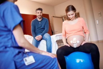 Mom on yoga ball with beltless pod and patch