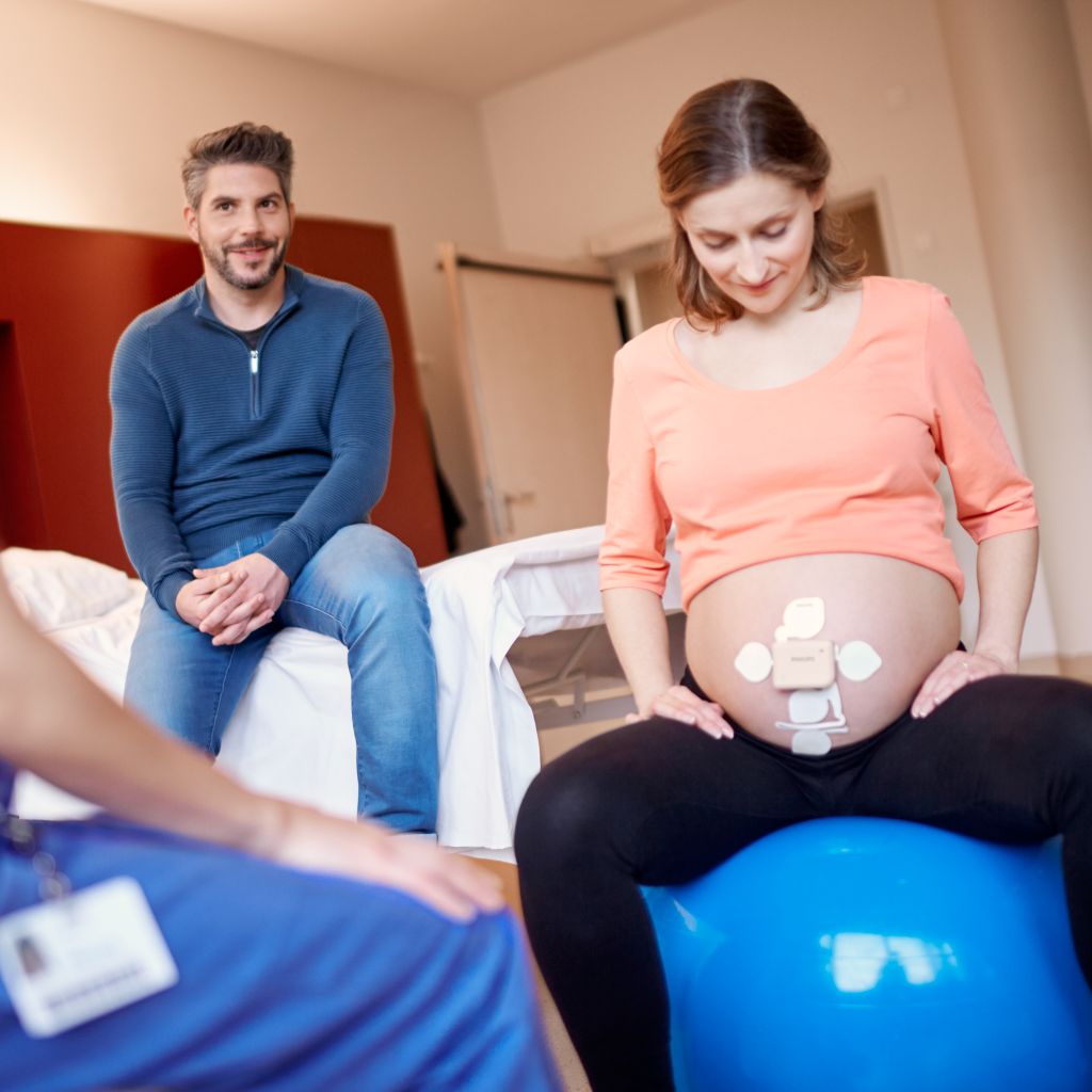 Mom on yoga ball with beltless pod and patch