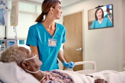 Nurse and patient in eICU using tele-critical care