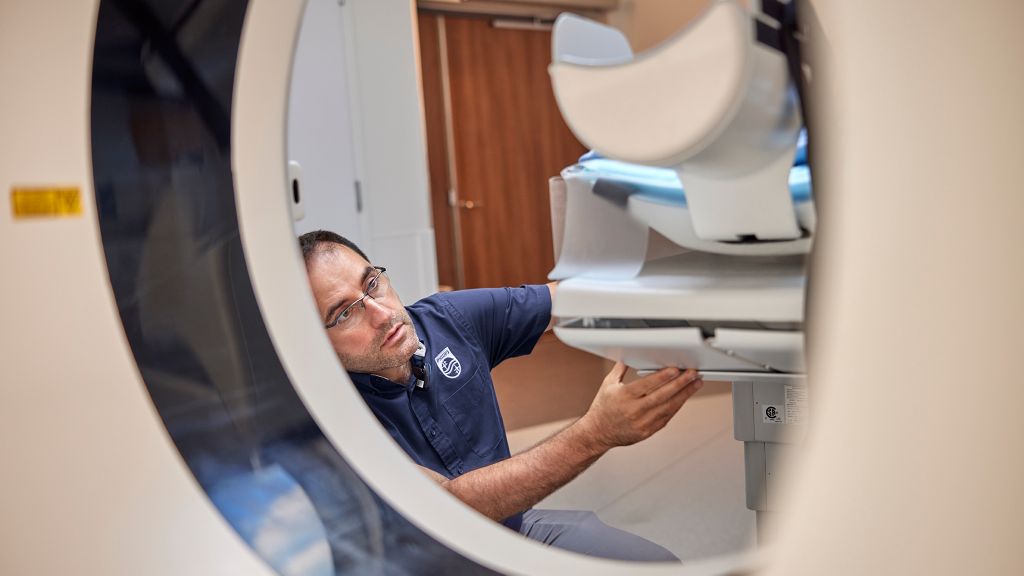 Service technician examines hospital equipment