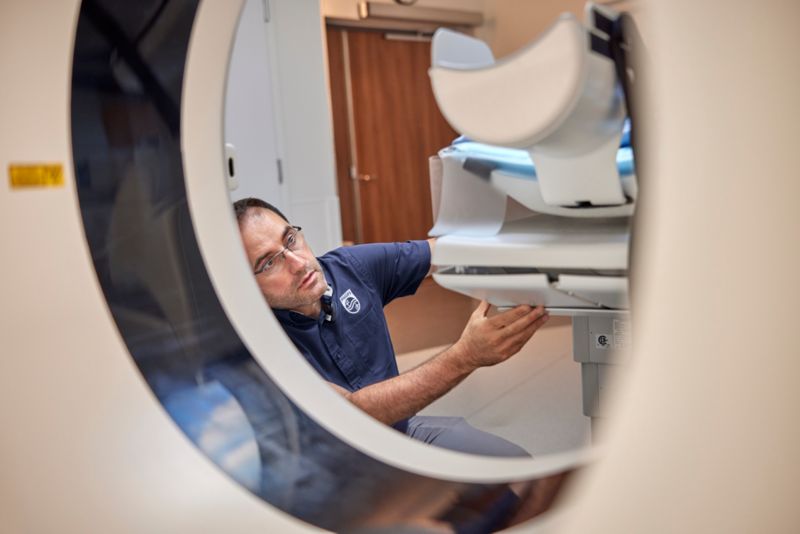 Service technician examines hospital equipment