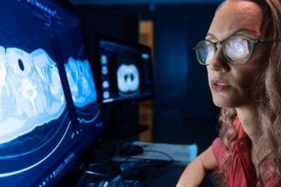 Clinician reviewing CT images on dual monitor radiology workstation
