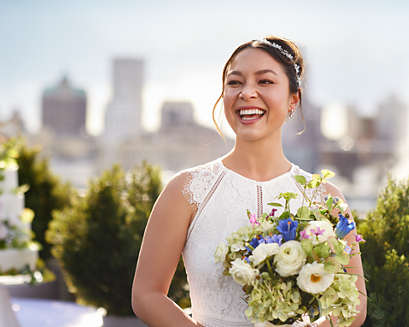The woman smiling at a wedding with bright, white teeth