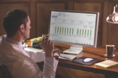 Male clinician or homecare provider reviews patient data via Care Orchestrator 