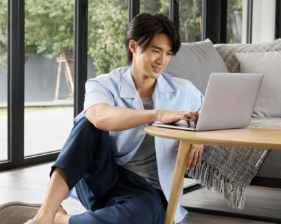 Clean shaven man working from home on a laptop