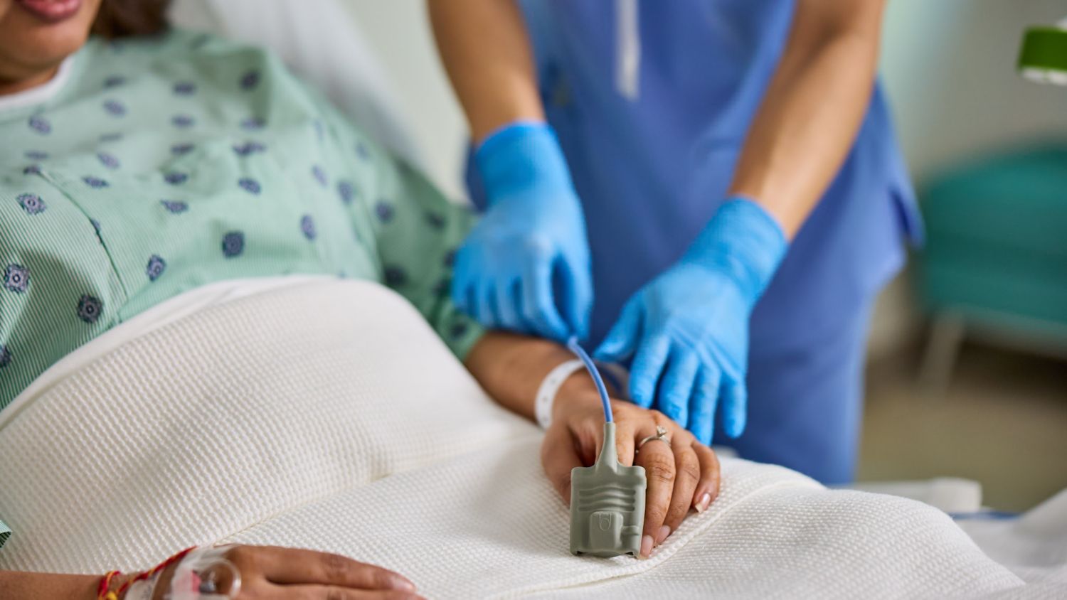 patient with Philips Spo2 sensor and clinician at bedside