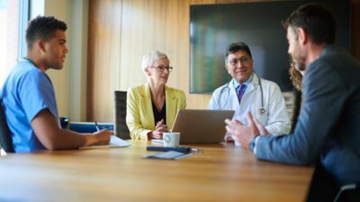 A group of professionals having a discussion around a conference table