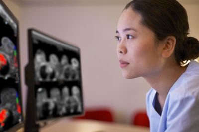 doctor at desk with monitors