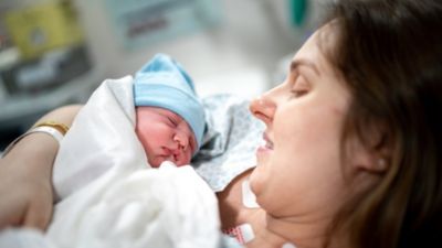 A mother holding her newborn.