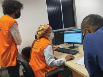 Healthcare team using Philips Tasy system on computer for patient data management