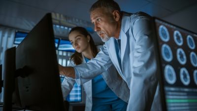 Clinicians reviewing medical imaging on screens in diagnostic setting