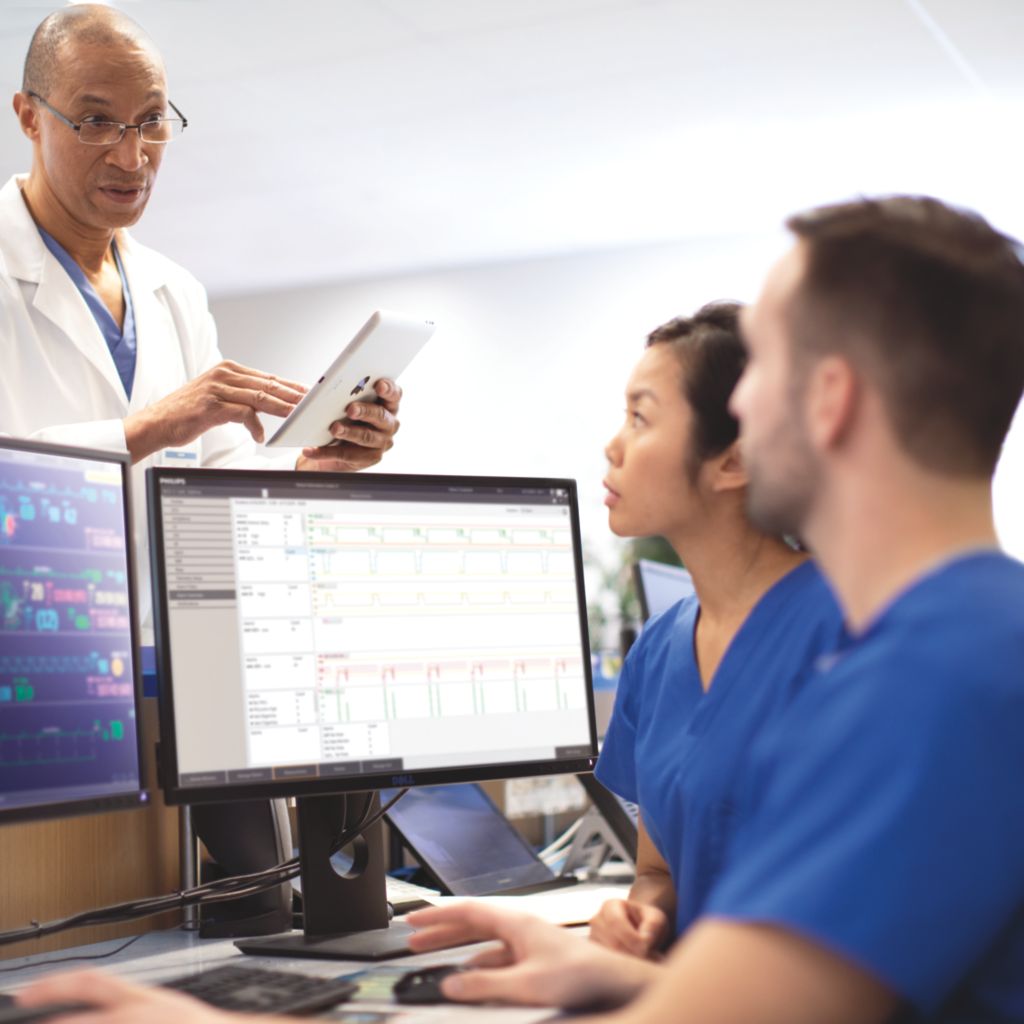 Physician consulting with clinicians at PIC iX central station