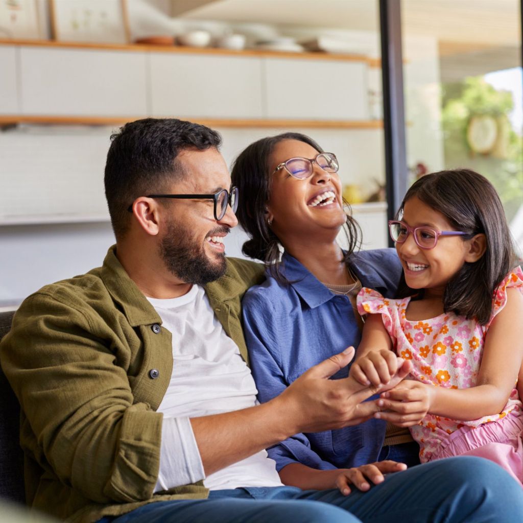Family on couch laughing