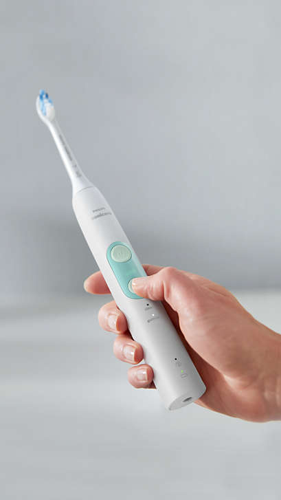 Hand holding a ProtectiveClean power toothbrush