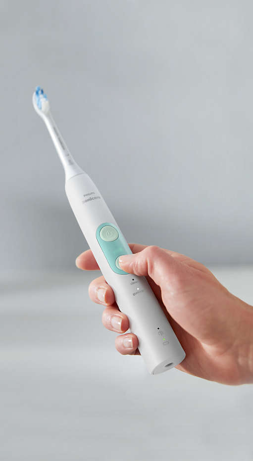 Hand holding a ProtectiveClean power toothbrush