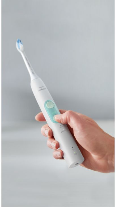 Hand holding a ProtectiveClean power toothbrush