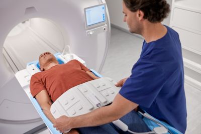 Clinician positioning patient on Philips MRI scanner for diagnostic imaging