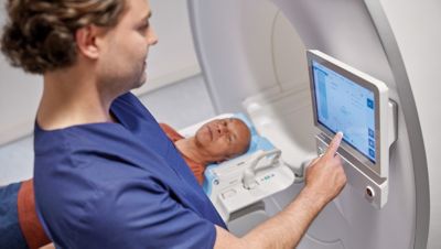 Clinician helping patient during MRI scan